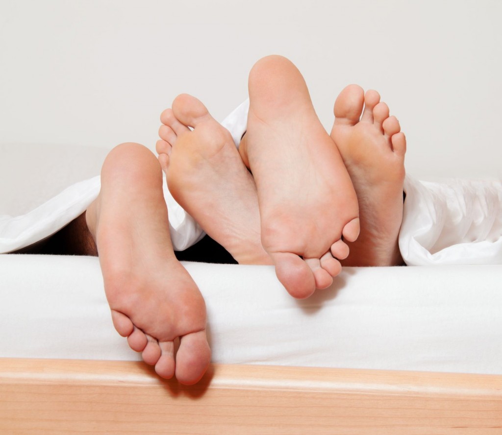 a couple feet in bed love, sex and partners