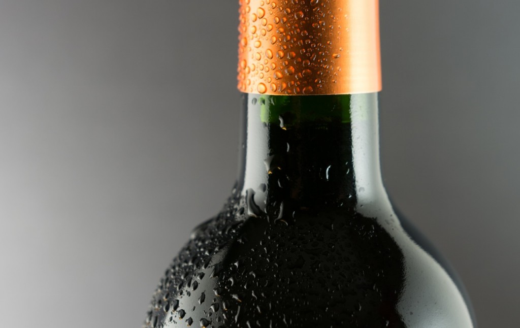 close up of wine bottle neck covered in condensation
